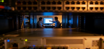 A network edge device on a rooftop connects to a city skyline through glowing blue digital pathways, illustrating AI-enabled, resilient IT infrastructure and high-speed connectivity.